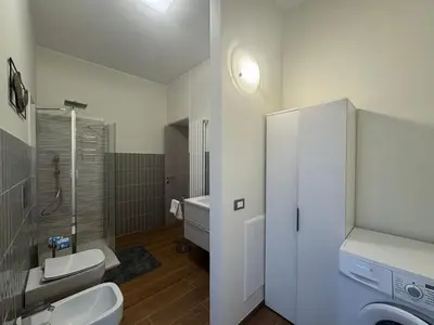 a bathroom with a toilet and a sink and a shower at Grazia s Elegant Roman Haven with Terrace in Rome