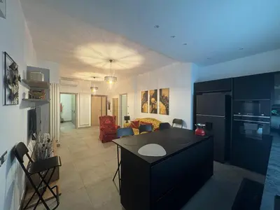 a kitchen with a black island in a room at Grazia s Elegant Roman Haven with Terrace in Rome