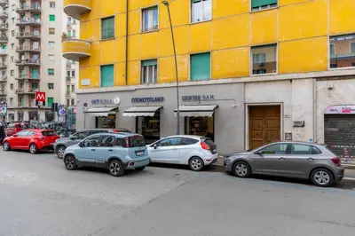 a group of cars parked in front of a building at Romano Apartments - 