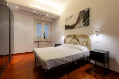 a bedroom with a bed and a window at Romano Apartments - 