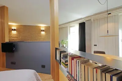 a bedroom with a book shelf filled with books at Onofrio in Rome
