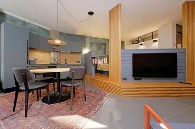 a kitchen and living room with a table and a tv at Onofrio in Rome