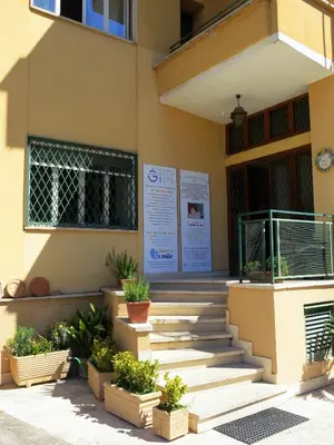a building with stairs and potted plants in front of it at Residenza Cimone in Rome
