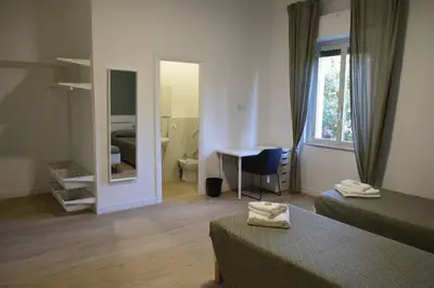 a room with a bedroom with a bed and a mirror at Residenza Cimone in Rome