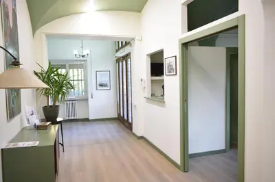 a hallway with a door leading to a living room at Residenza Cimone in Rome