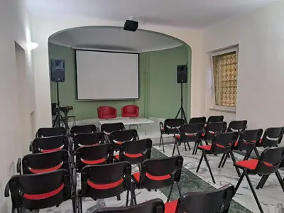 an empty room with chairs and a white board at Residenza Cimone in Rome