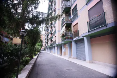 an empty street next to a row of apartment buildings at Inn Rhome 71 in Rome
