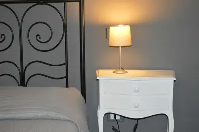 a bedroom with a bed and a lamp on a dresser at A Casa Di Giallo B&B in Rome