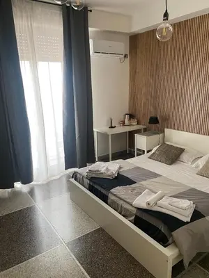 a bedroom with a large bed with blue curtains at A Casa Di Giallo B&B in Rome