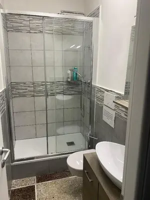 a bathroom with a shower and a toilet and a sink at A Casa Di Giallo B&B in Rome