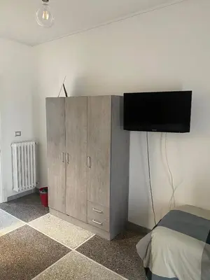a bedroom with a cabinet with a television on it at A Casa Di Giallo B&B in Rome