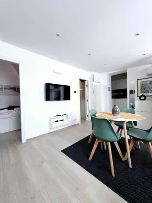 a dining room with a table and green chairs at Divine Terrace Stylish Apartment St Peter Rome in Rome