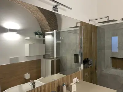 a bathroom with a shower and a sink at Divine Terrace Stylish Apartment St Peter Rome in Rome