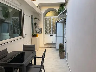 a hallway with a table and chairs in a building at Divine Terrace Stylish Apartment St Peter Rome in Rome