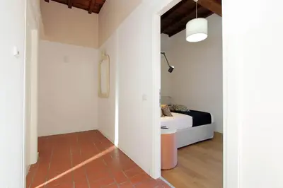a bedroom with a bed in a room with a hallway at Torre Argentina in Rome