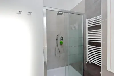 a bathroom with a shower with a glass door at Torre Argentina in Rome