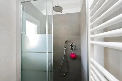 a shower with a glass door in a bathroom at Torre Argentina in Rome