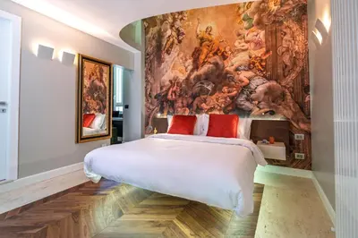 a bedroom with a painting on the wall at Dreamers in Belsiana Condotti Int 9 in Rome