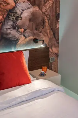 a bedroom with a bed with a painting on the wall at Dreamers in Belsiana Condotti Int 9 in Rome