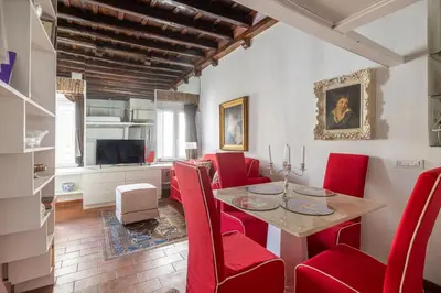 a dining room with a table and red chairs at Elegant Studio in the Center in Rome