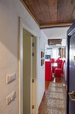 a hallway with a door and a red couch at Elegant Studio in the Center in Rome