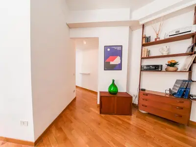 a living room with a wooden floor and white walls at Central Boutique Apartment for2 in Rome