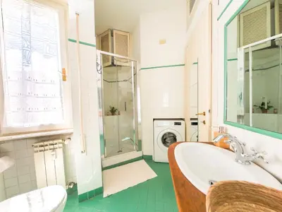 a bathroom with a sink and a washing machine at Central Boutique Apartment for2 in Rome