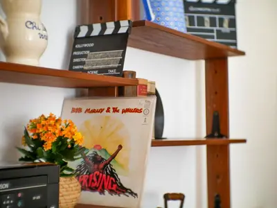 a book shelf with books and a vase of flowers at Central Boutique Apartment for2 in Rome