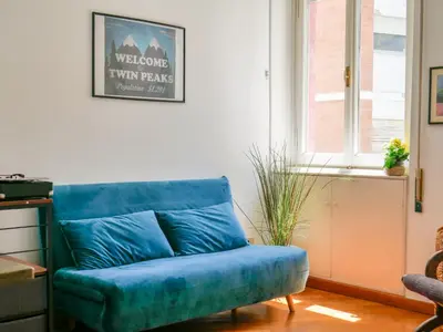 a blue couch in a living room with a window at Central Boutique Apartment for2 in Rome