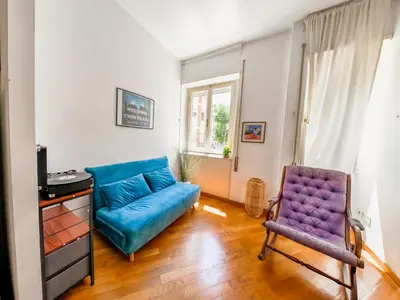 a living room with a blue couch and a chair at Central Boutique Apartment for2 in Rome