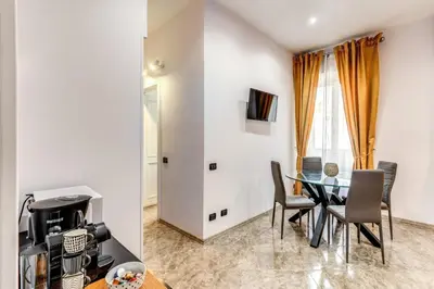 a dining room with a table and chairs at Apartment near Via Veneto in Rome
