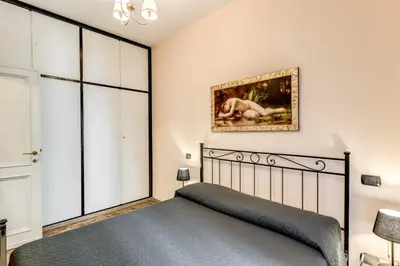 a bedroom with a bed and a painting on the wall at Apartment near Via Veneto in Rome