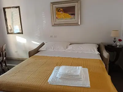 a bed with two towels on top of it at Your window on San Pietro in Rome