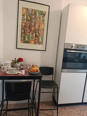 a kitchen with a table with a plate of fruit on it at Your window on San Pietro in Rome