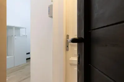 a door with a black door knob in a kitchen at Elegant suite in Prati, 5 minutes from the Vatican in Rome