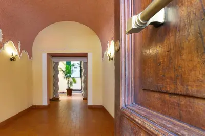 a hallway with an archway and a door in a house at Elegant suite in Prati, 5 minutes from the Vatican in Rome