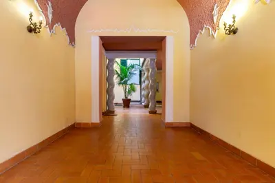 a hallway with a tile floor and an archway at Elegant suite in Prati, 5 minutes from the Vatican in Rome