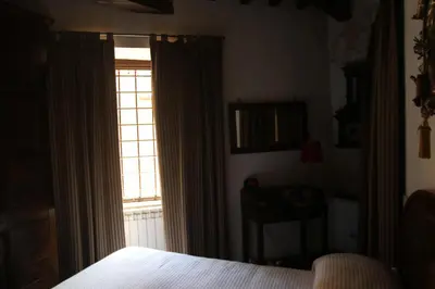 a bedroom with a bed and a window with curtains at Campo dei Fiori Jewel in Rome