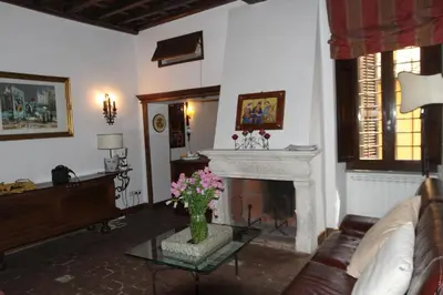 a living room with a couch and a fireplace at Campo dei Fiori Jewel in Rome