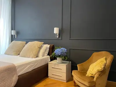 a bedroom with a bed and a chair and flowers at Banchi Vecchi Stay Rooms in Rome