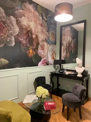 a room with a table and a flower mural at Banchi Vecchi Stay Rooms in Rome