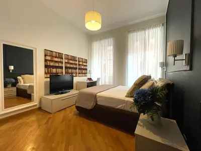 a bedroom with a bed and a television in it at Banchi Vecchi Stay Rooms in Rome