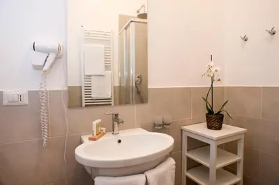 a bathroom with a white sink and a mirror at Banchi Vecchi Stay Rooms in Rome