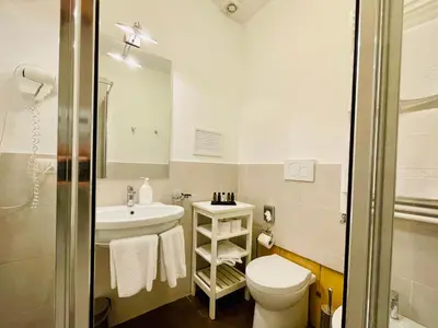 a bathroom with a toilet and a sink at Banchi Vecchi Stay Rooms in Rome