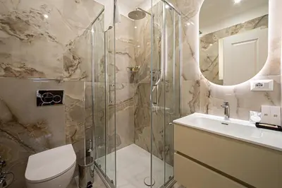 a bathroom with a shower and a toilet and a sink at L'Angolo Sereno Guesthouse Rome Termini in Rome