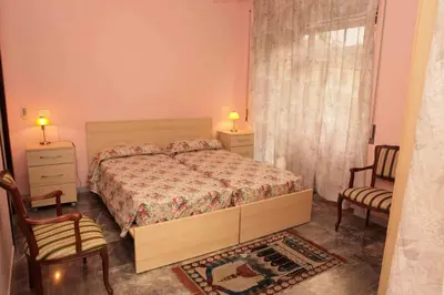 a bedroom with a bed and two chairs and a window at Ipanema B&B in Rome