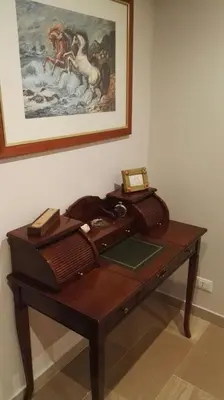 a wooden desk in a room with a picture on the wall at A Casetta Nostra in Rome
