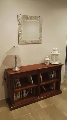 a wooden table with a mirror on a wall at A Casetta Nostra in Rome
