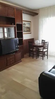 a living room with a tv and a table with chairs at A Casetta Nostra in Rome