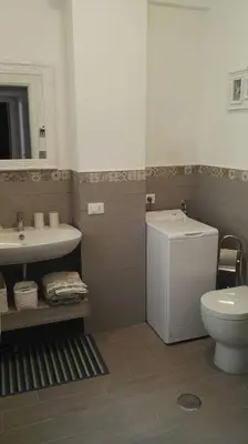 a bathroom with a toilet and a sink at A Casetta Nostra in Rome